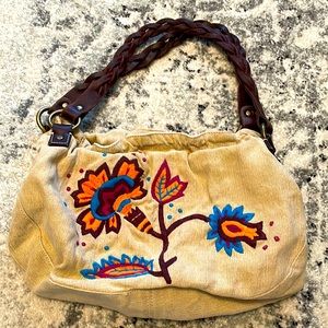 Lucky Brand purse with unique flower design and leather strap/handle